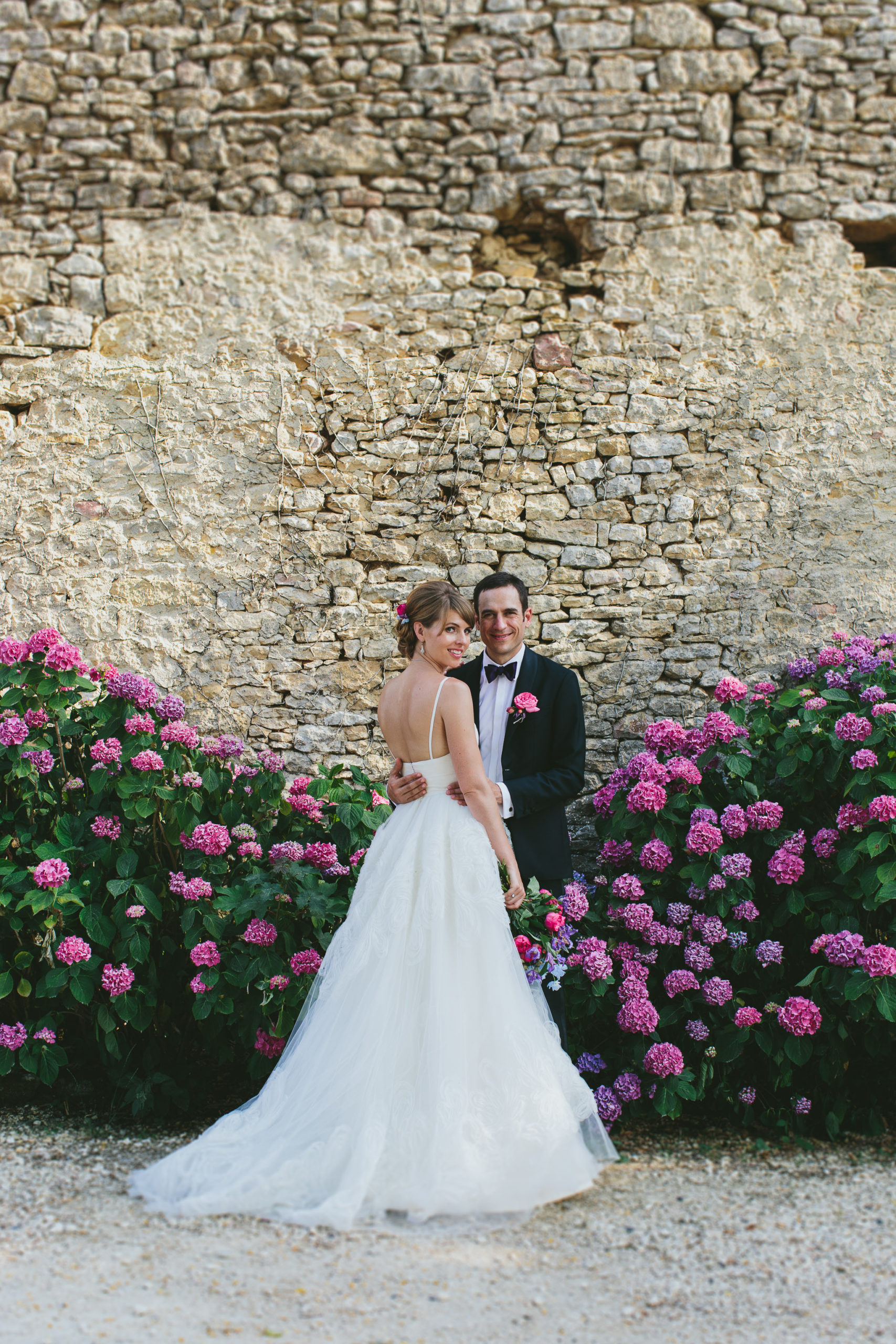 French professional wedding photographer married couple captured in front of a bush of hydrangeas