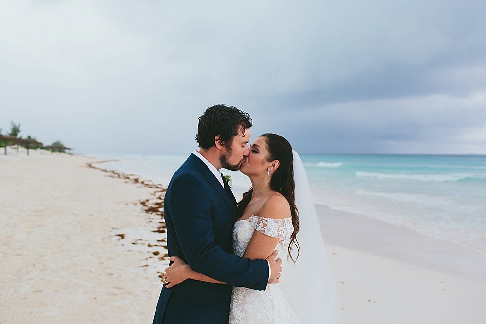 Bahamian wedding bride and groom kissing on the beach