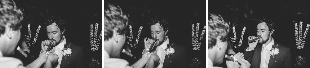 Bahamian wedding groomsman and groom cigar