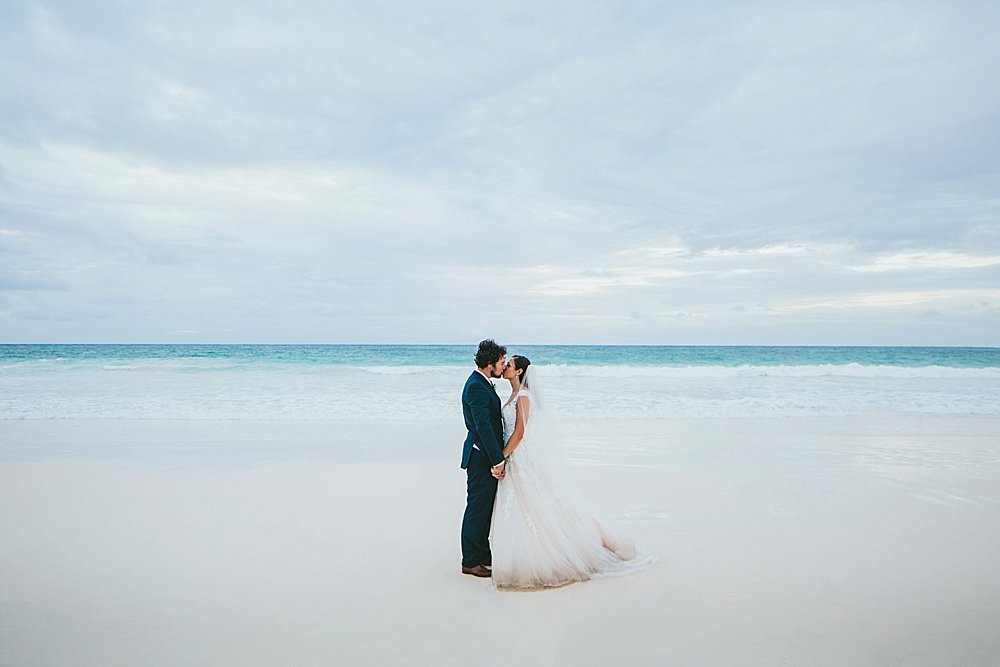Bahamian wedding bride and groom long kiss on the beach