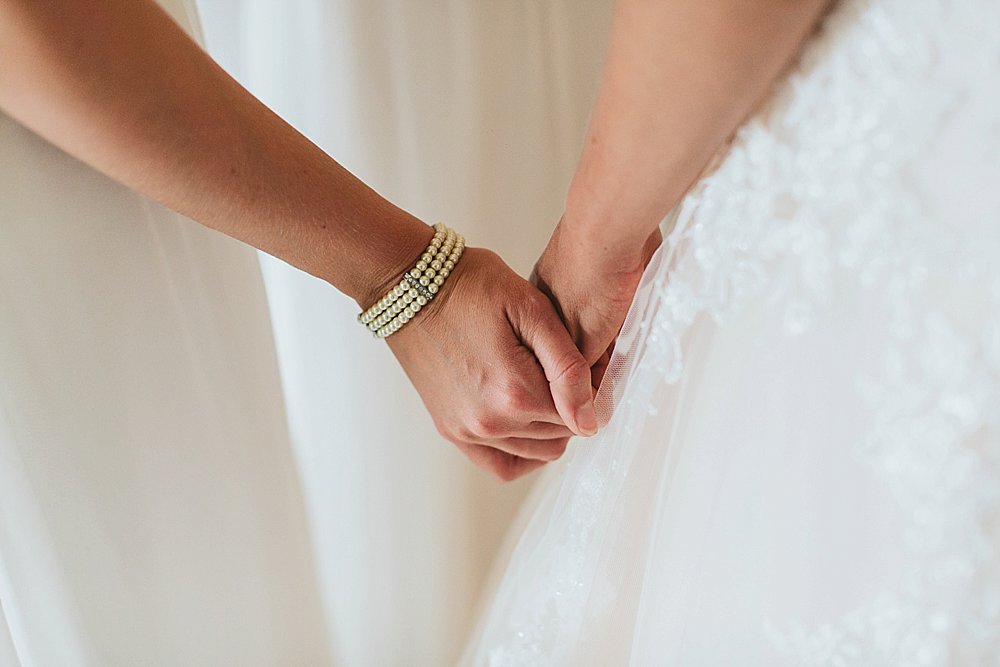 Bahamian bride and bridesmaids holding hands