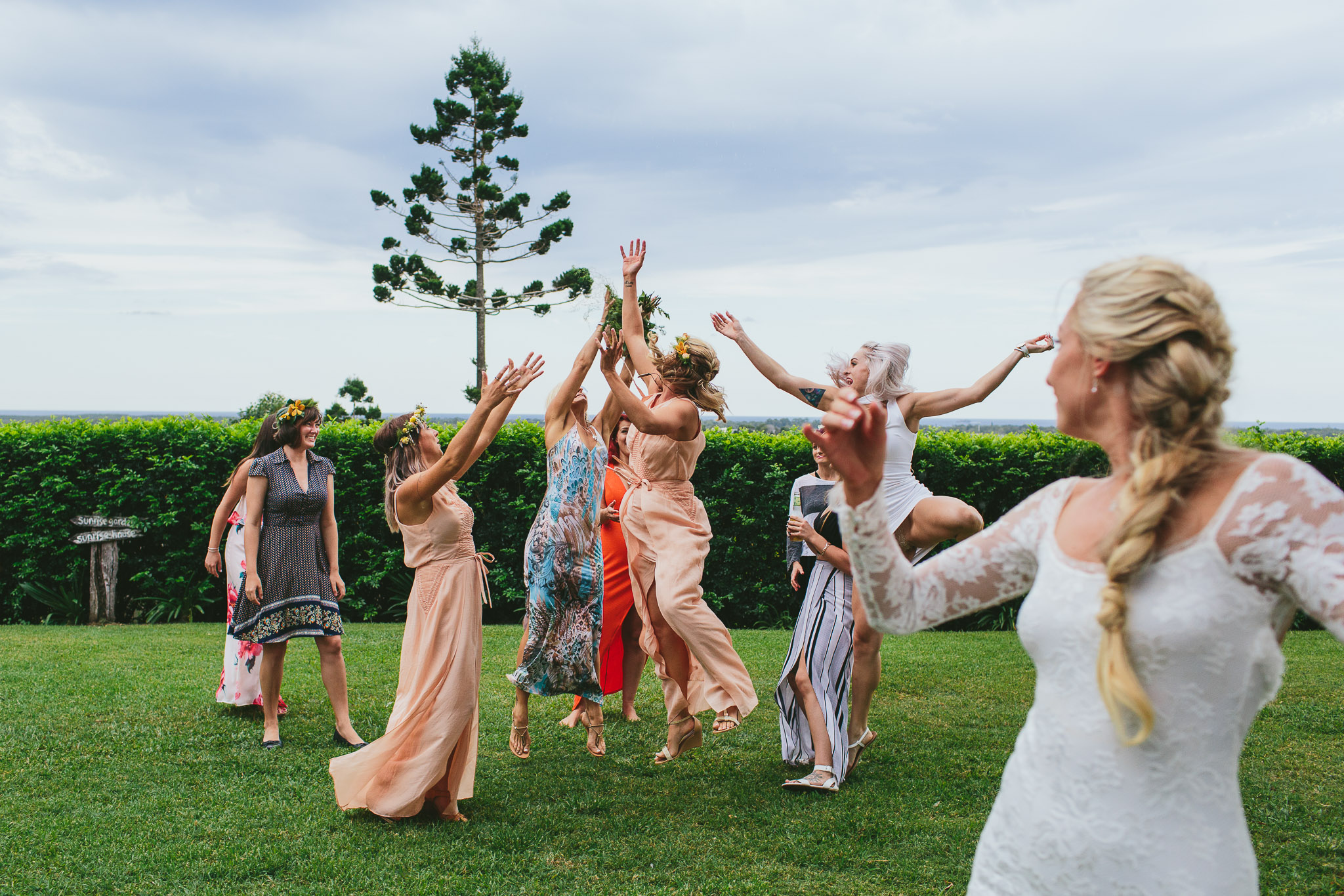 Byron Bay weddings ladies catching the throwing of the wedding bouquet