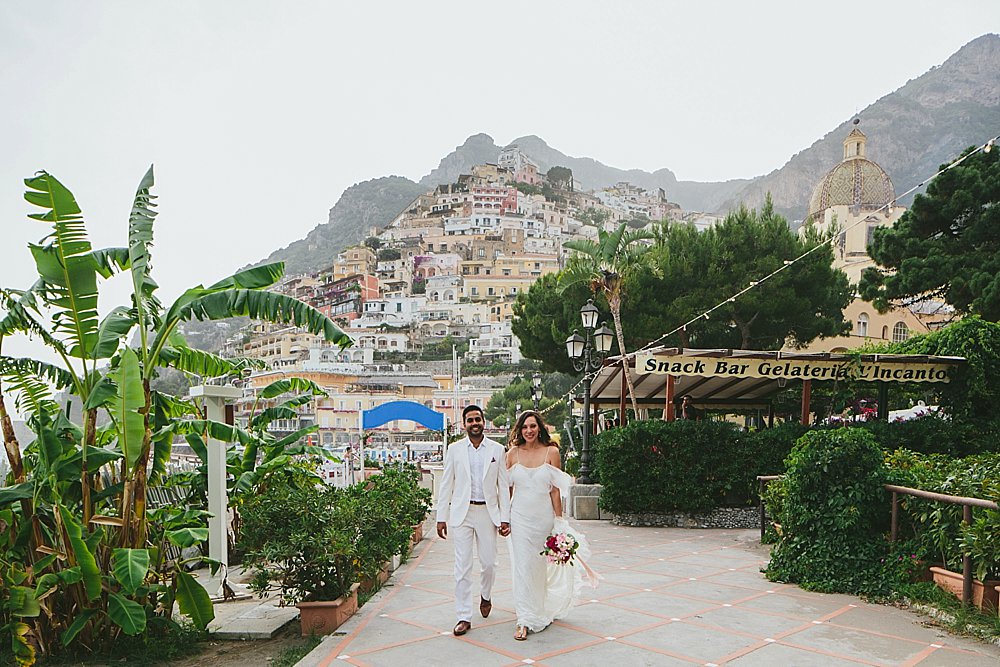 Positano wedding bride and groom walking on the beach