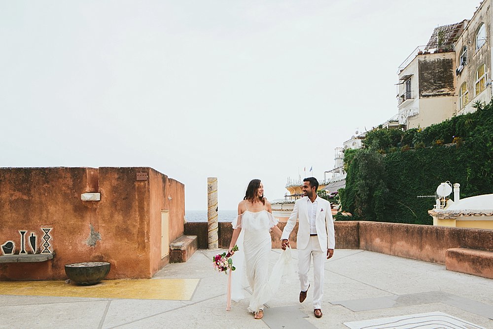 Positano wedding bride and groom walking hand in hand