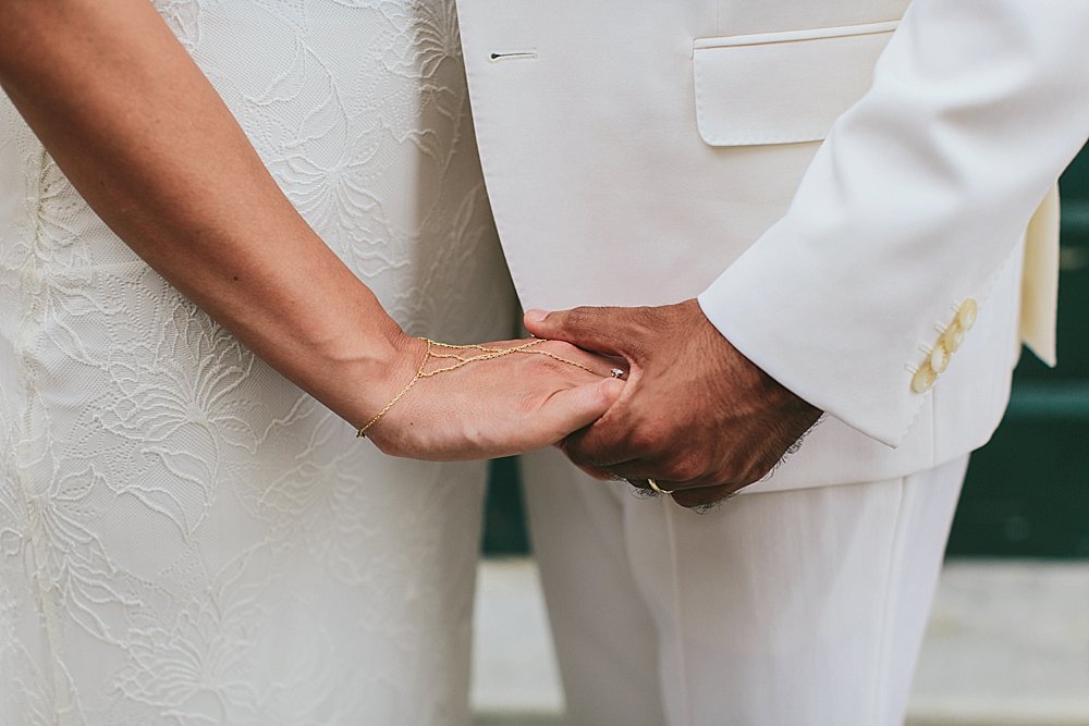 bride and groom holding hands