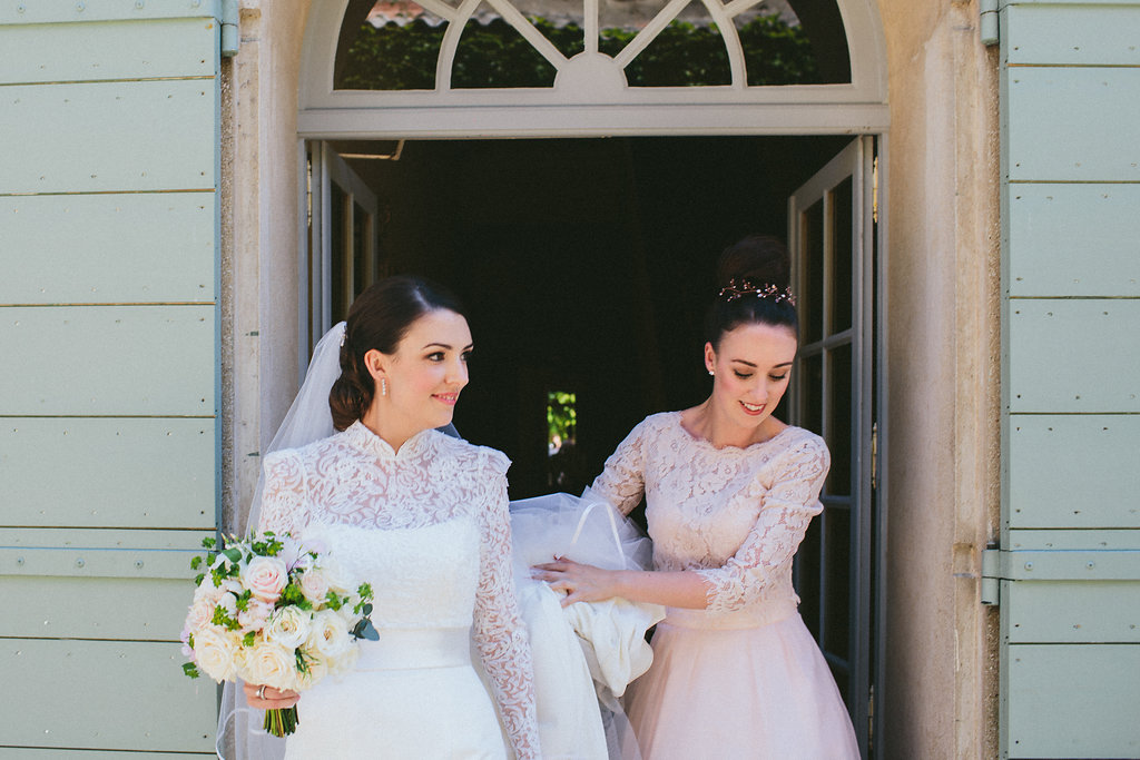 bride and her bridesmaid walking to church