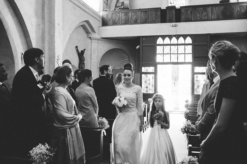 bridesmaid and flower girl walking down the aisle