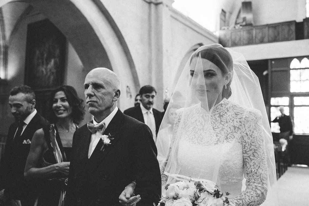 father and daughter walking down the aisle