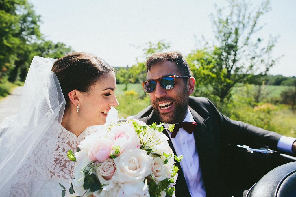 Provence wedding Bride and Groom laughs back of car