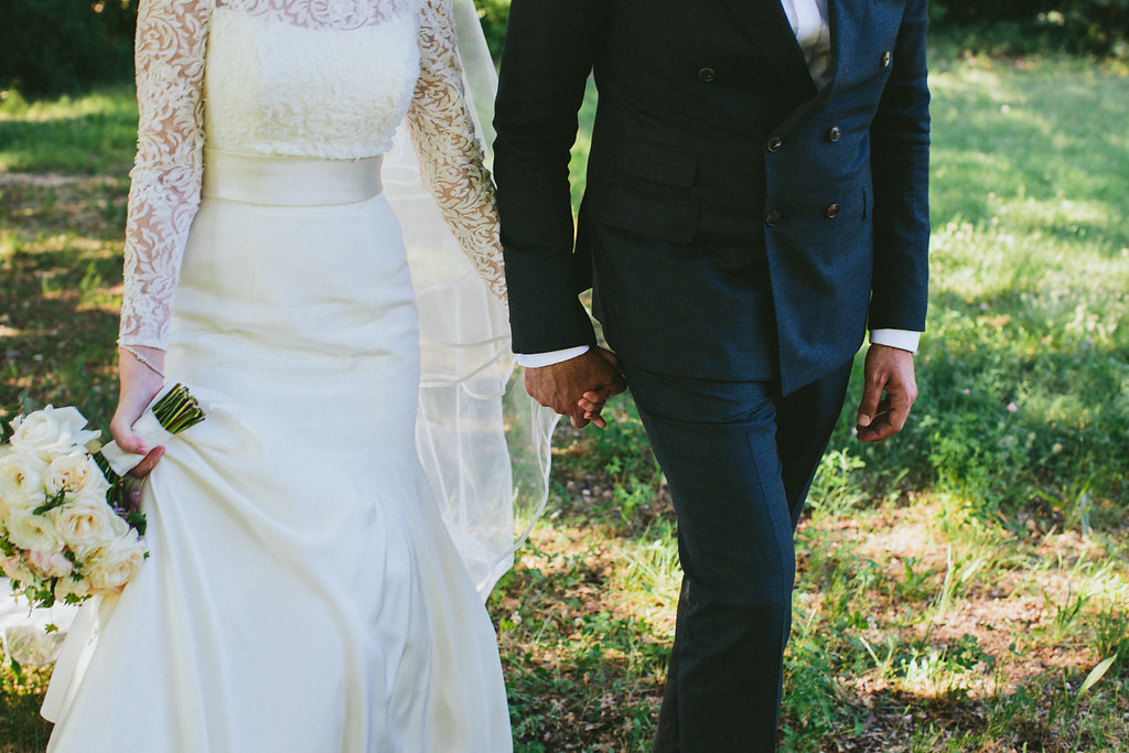 bride and groom holding hands