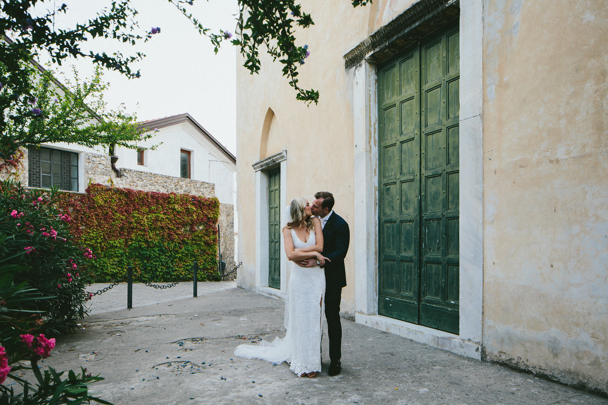 Bride and groom hugs and kisses his bride