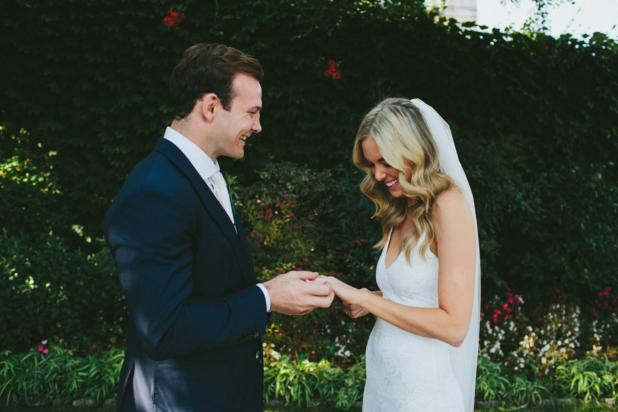 Groom put a ring on brides finger 