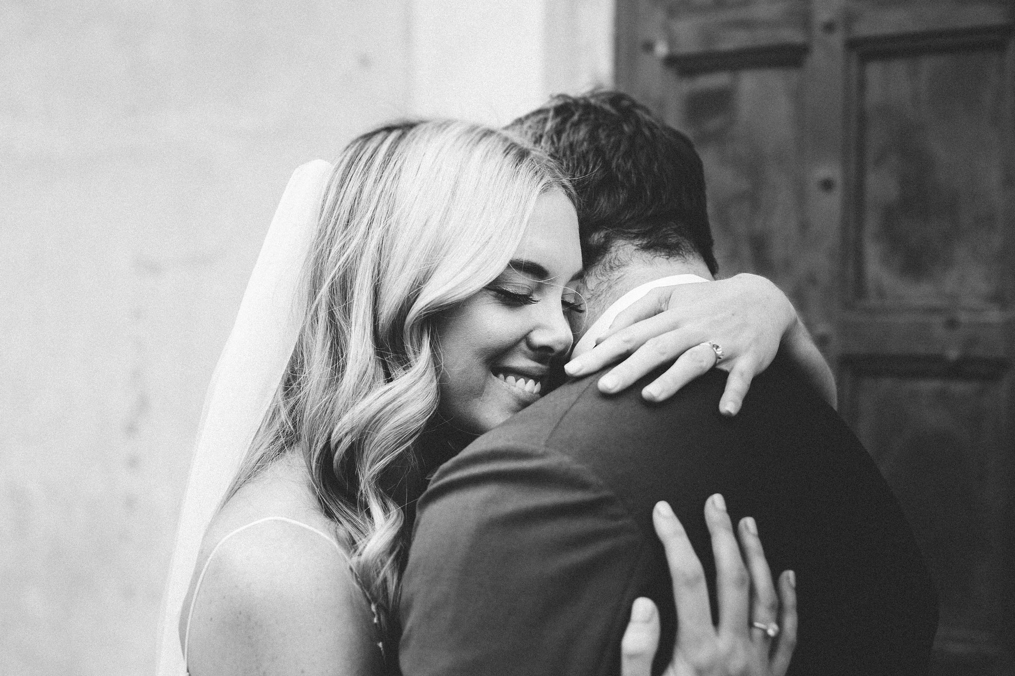 Bride and her groom holding each other tight