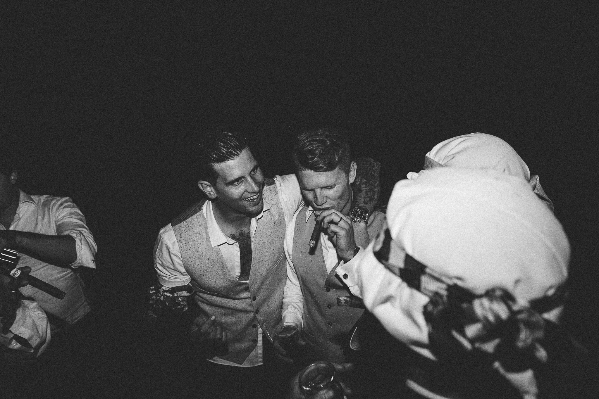A french destination wedding groom and best man smoking cigars