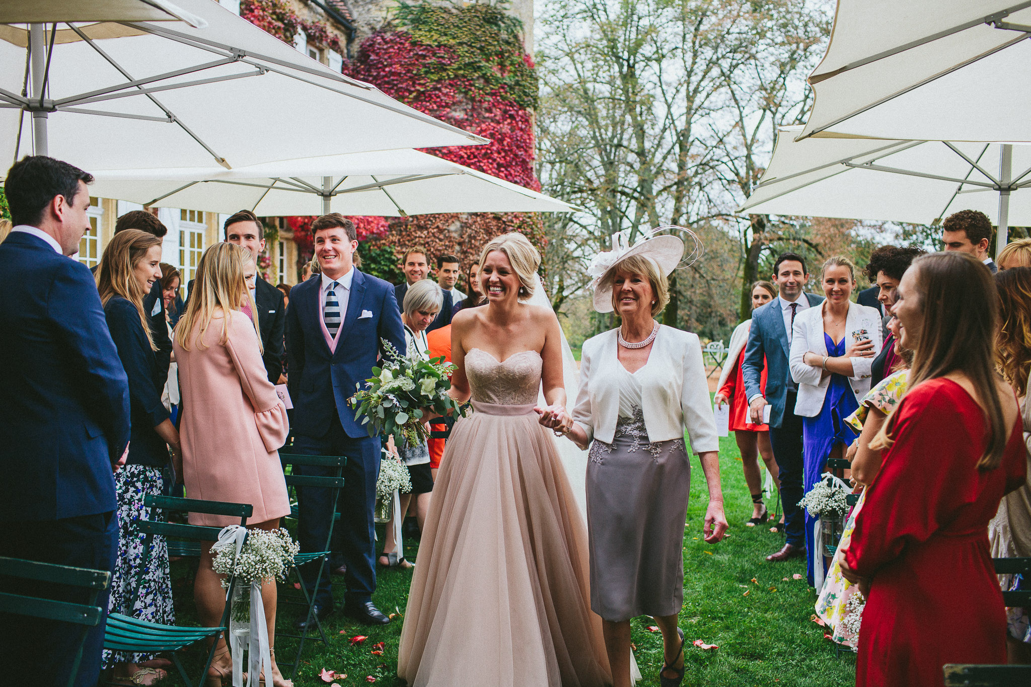 bride and mother of the bride walking down the aisle