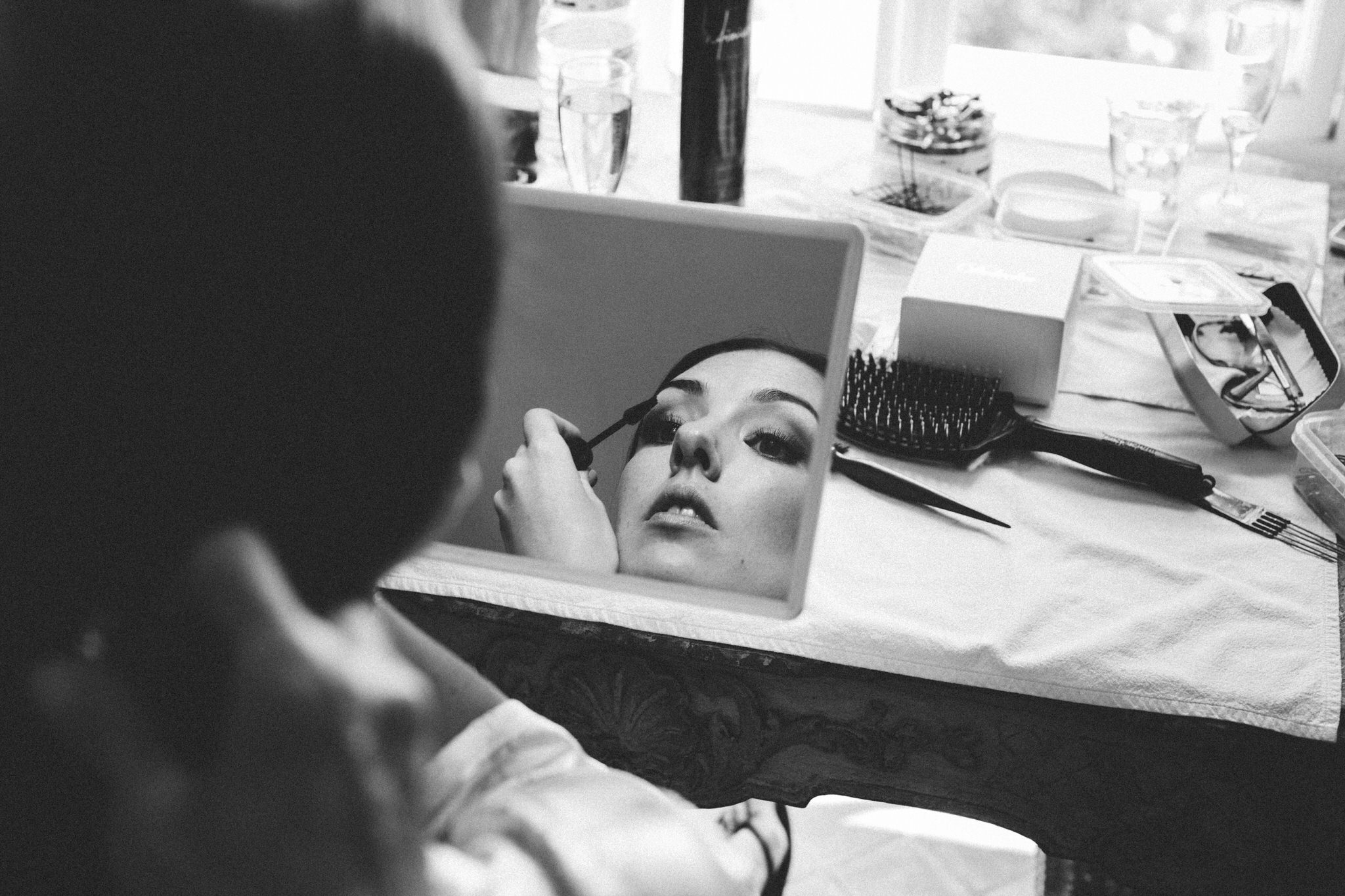 Bride putting makeup on 