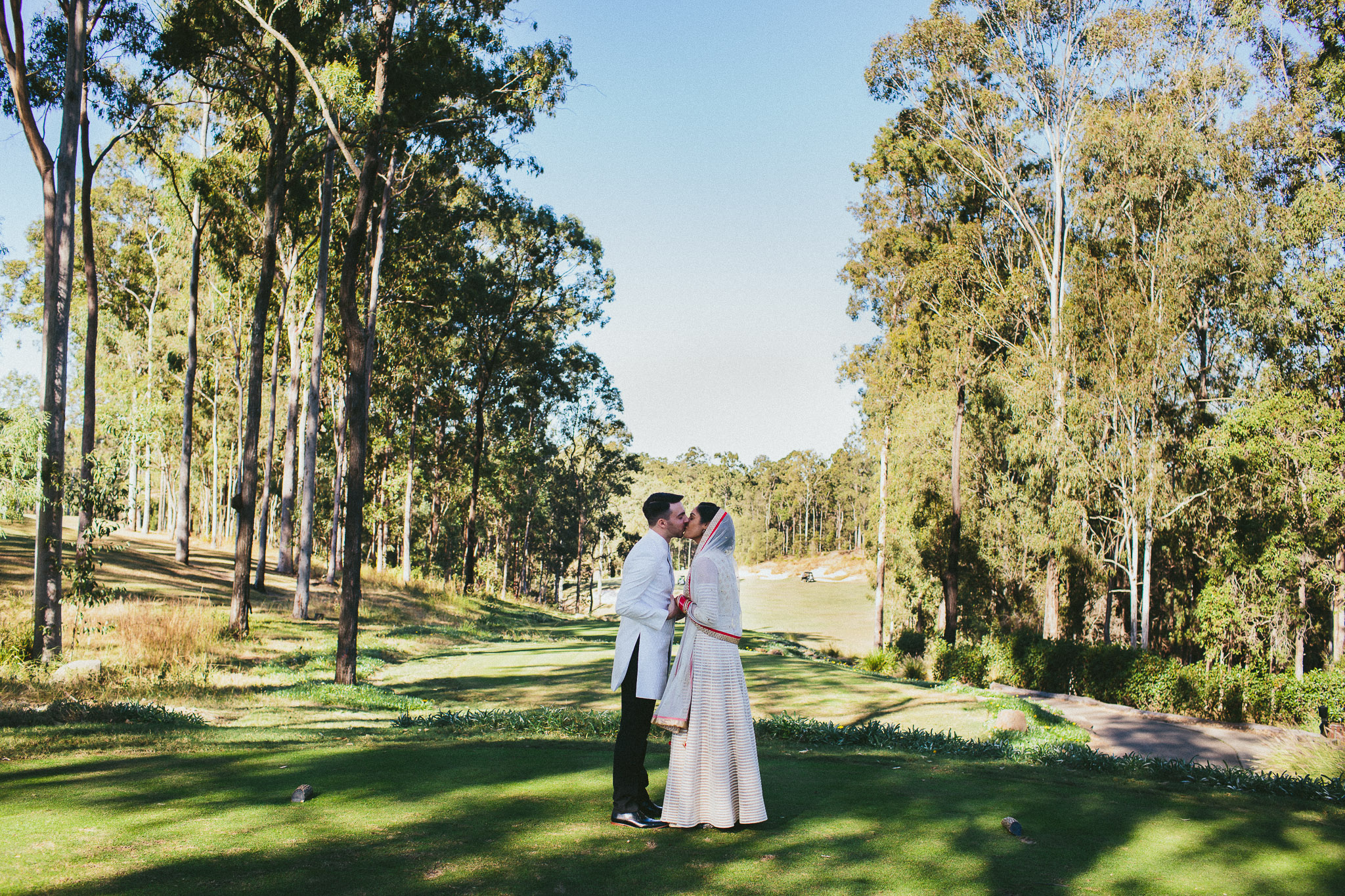Indian bride an groom kissing