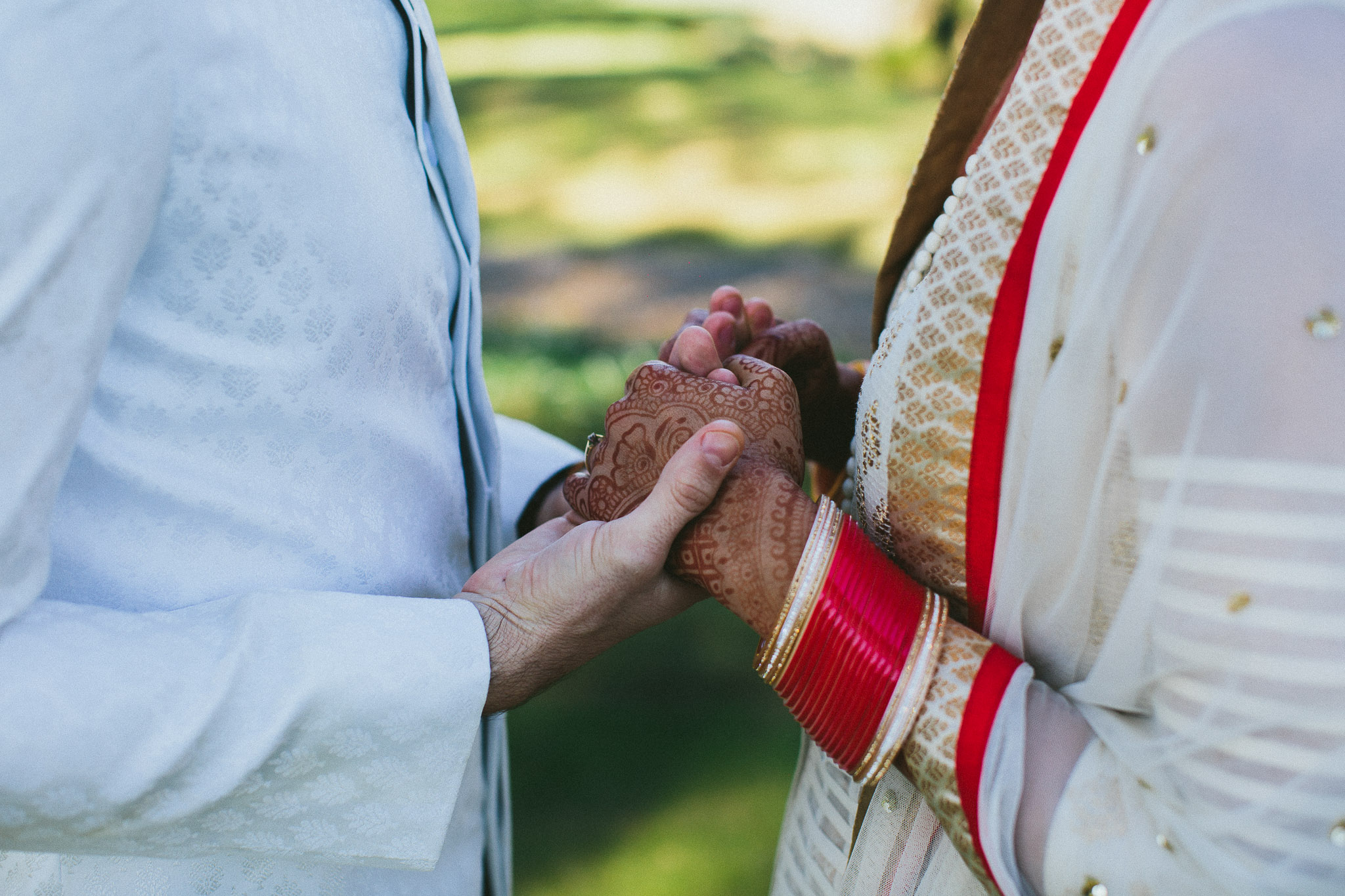 bride and groom holding hands Indian wedding