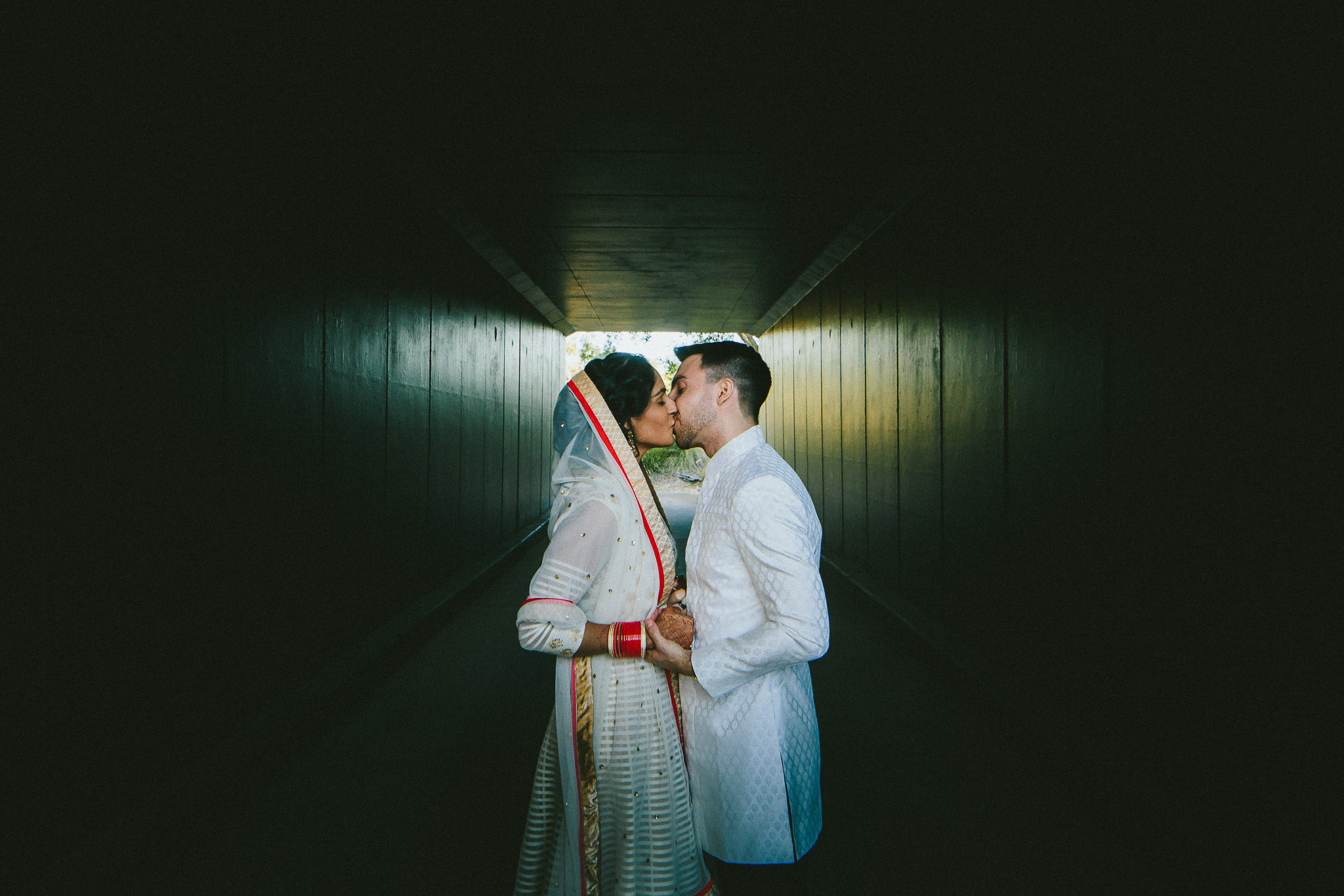 Indian weddings bride and groom kissing