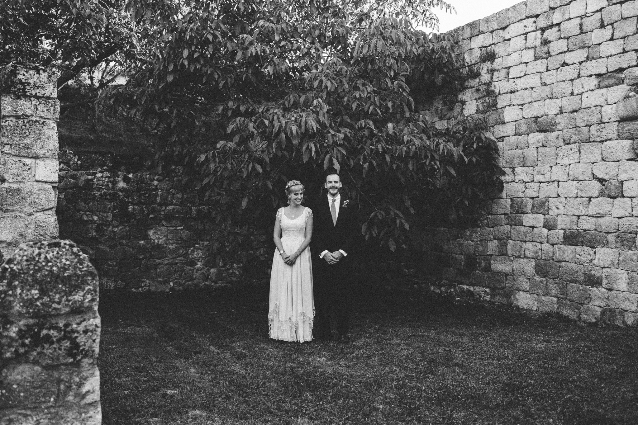 bride standing next to groom facing camera photoshoot