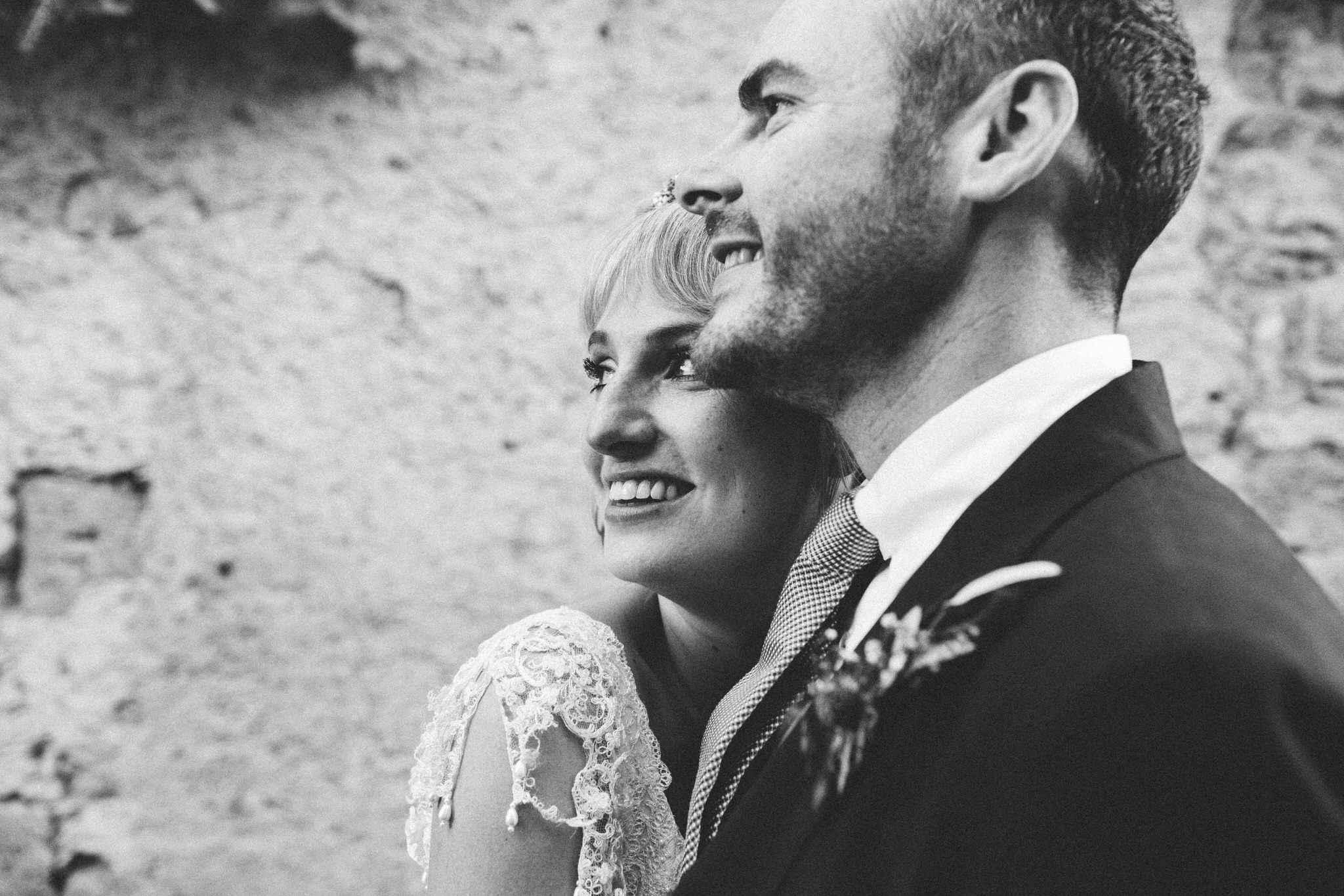 bride and groom looking into the distance together