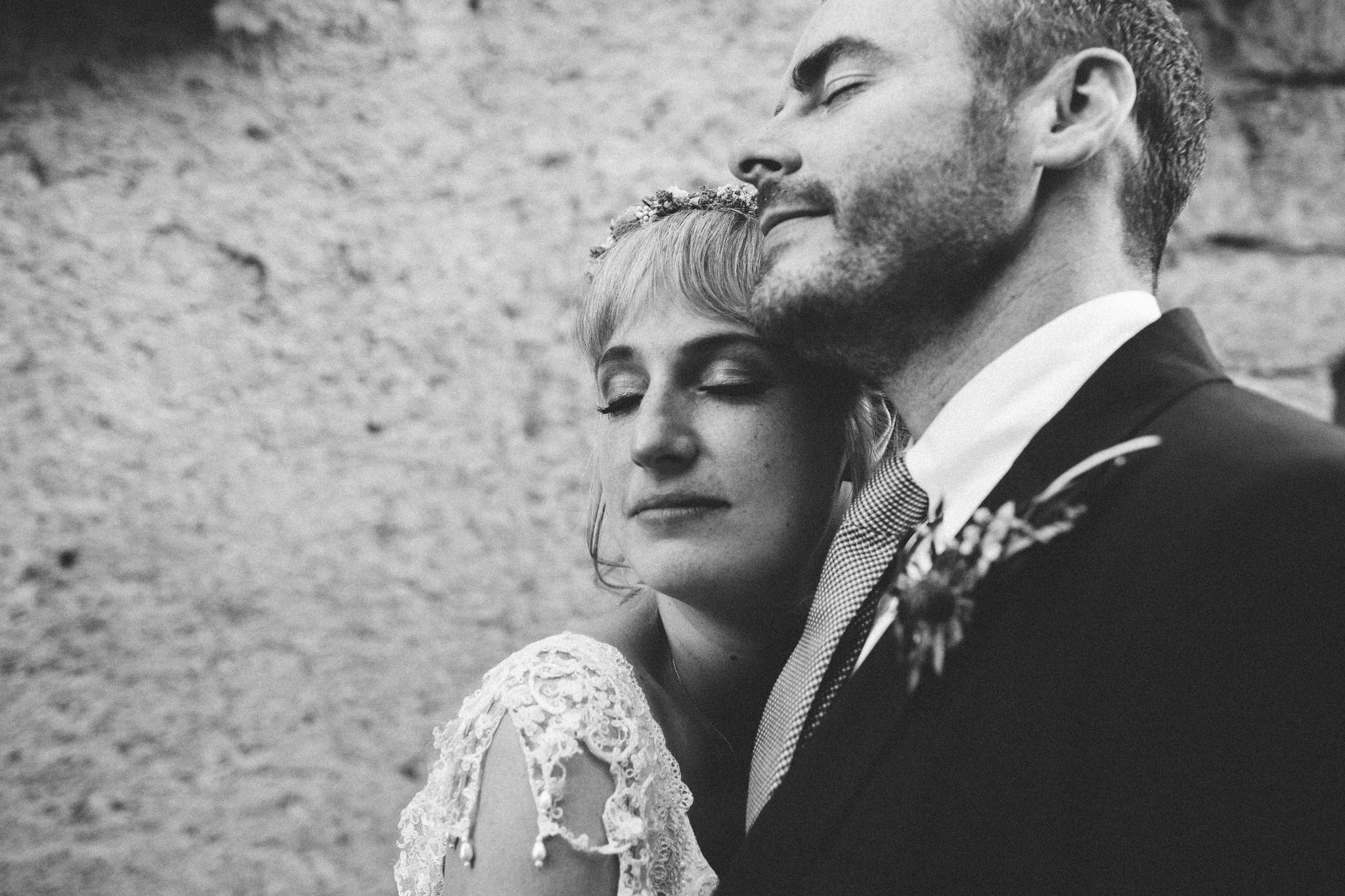 bride and groom eyes closed and hugs