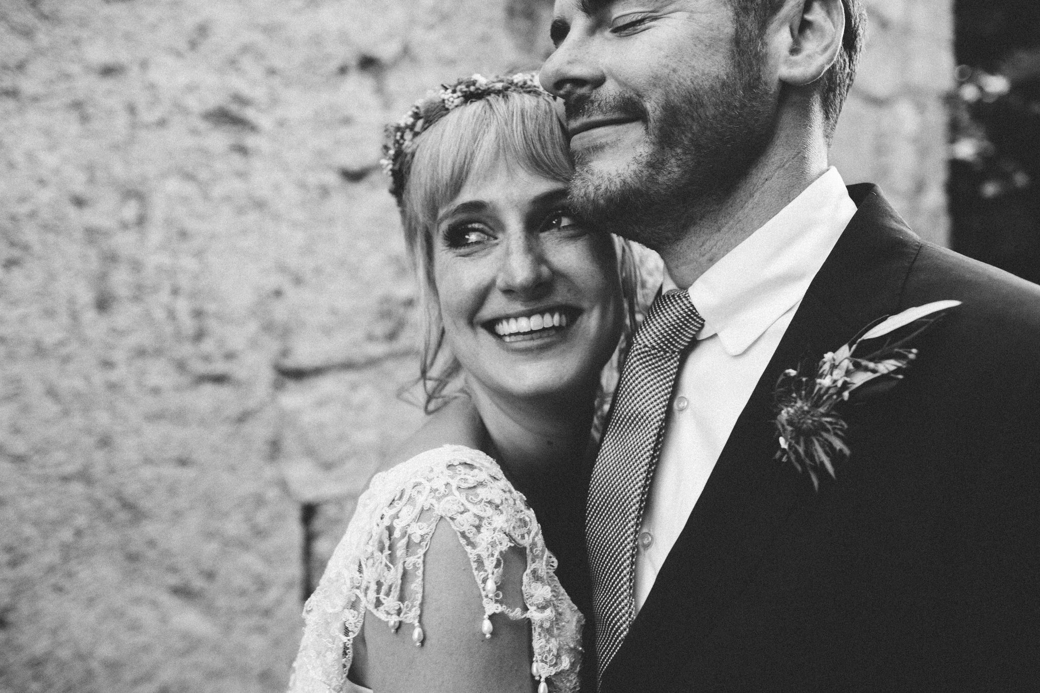 bride and groom looking into the distance smiles