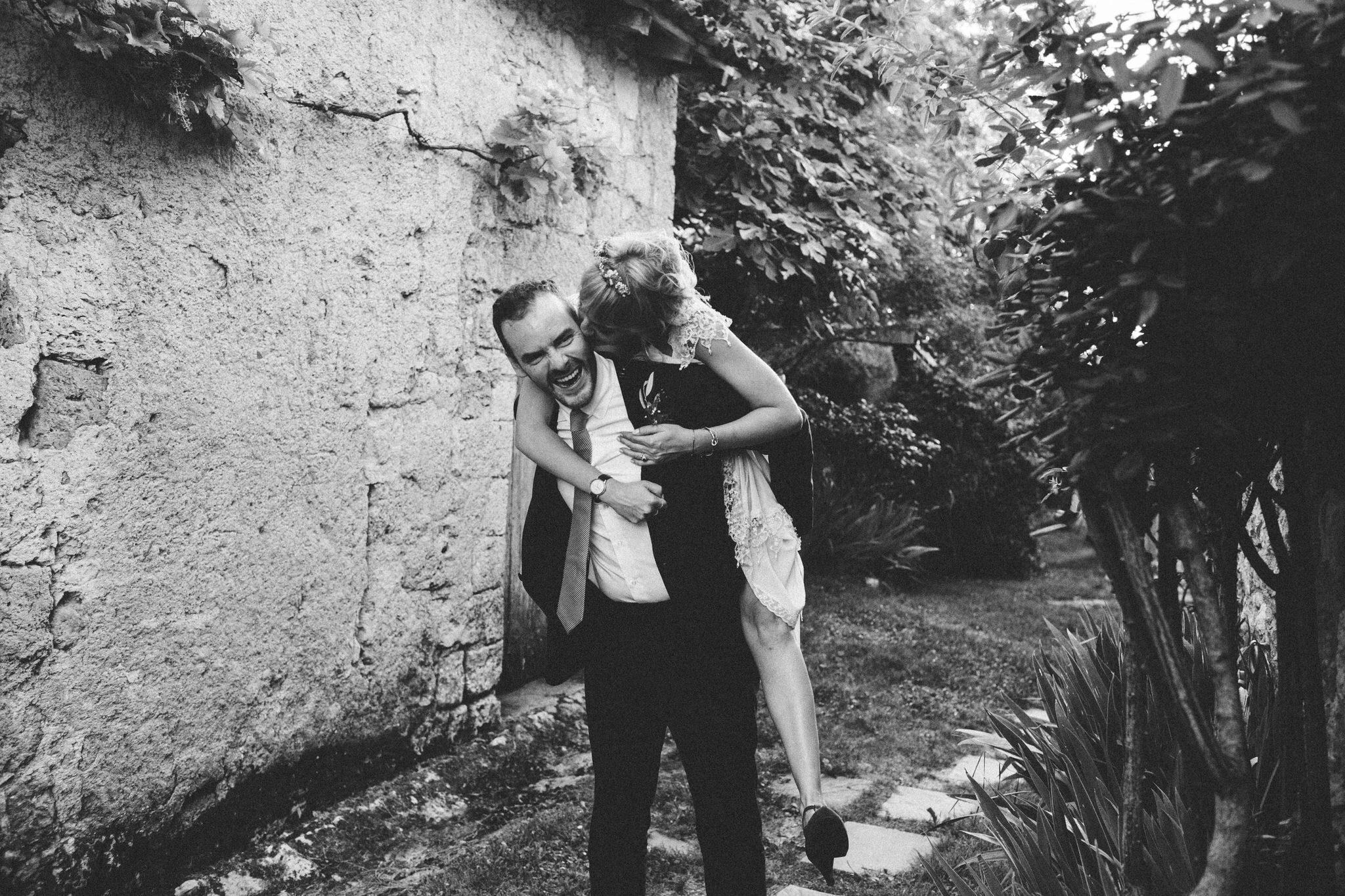 groom giving piggyback ride to bride 