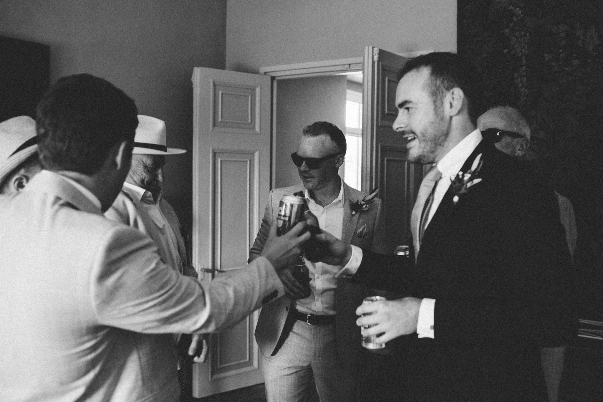 groom drinks with groomsman