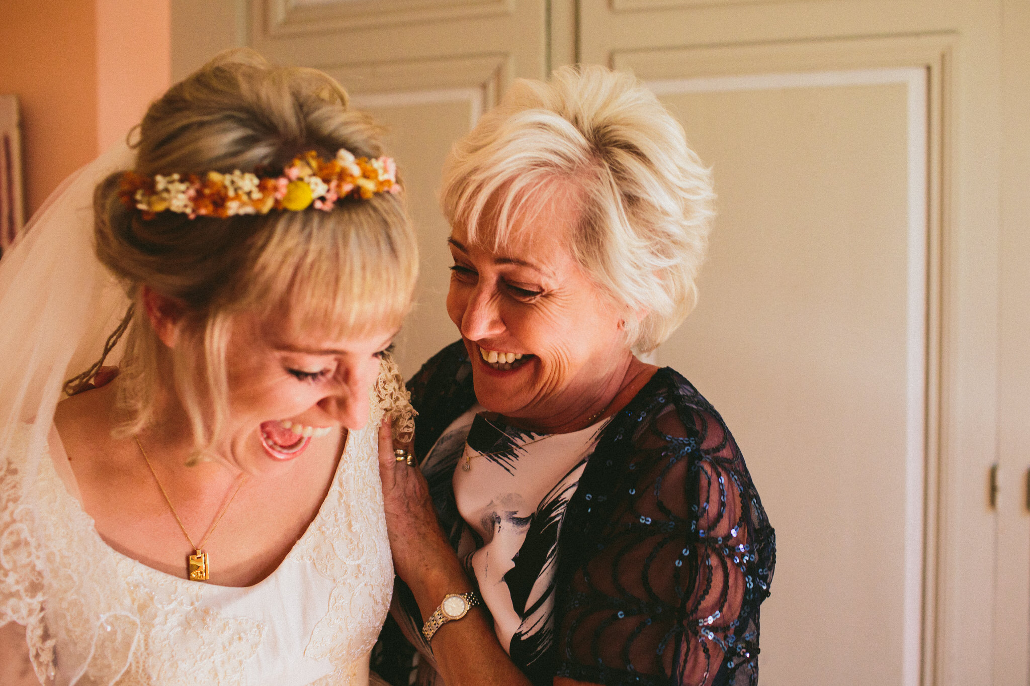 brides and mother of the bride laughs french wedding