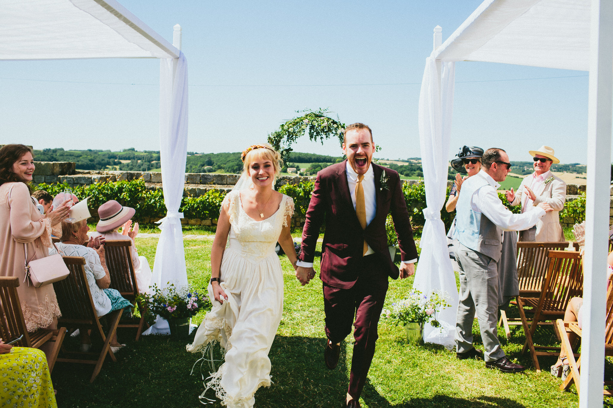 bride and groom going down aisle french wedding