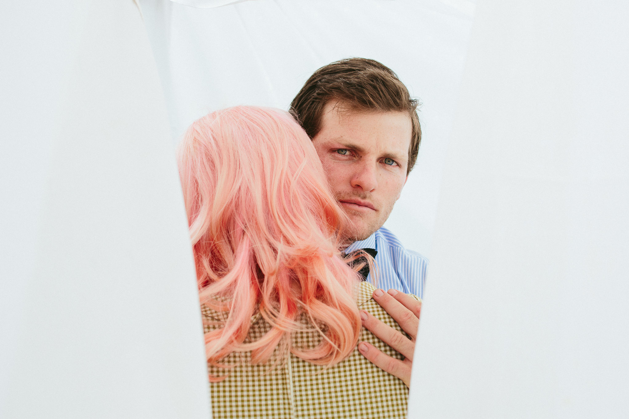 engagement couple hugging in sheets