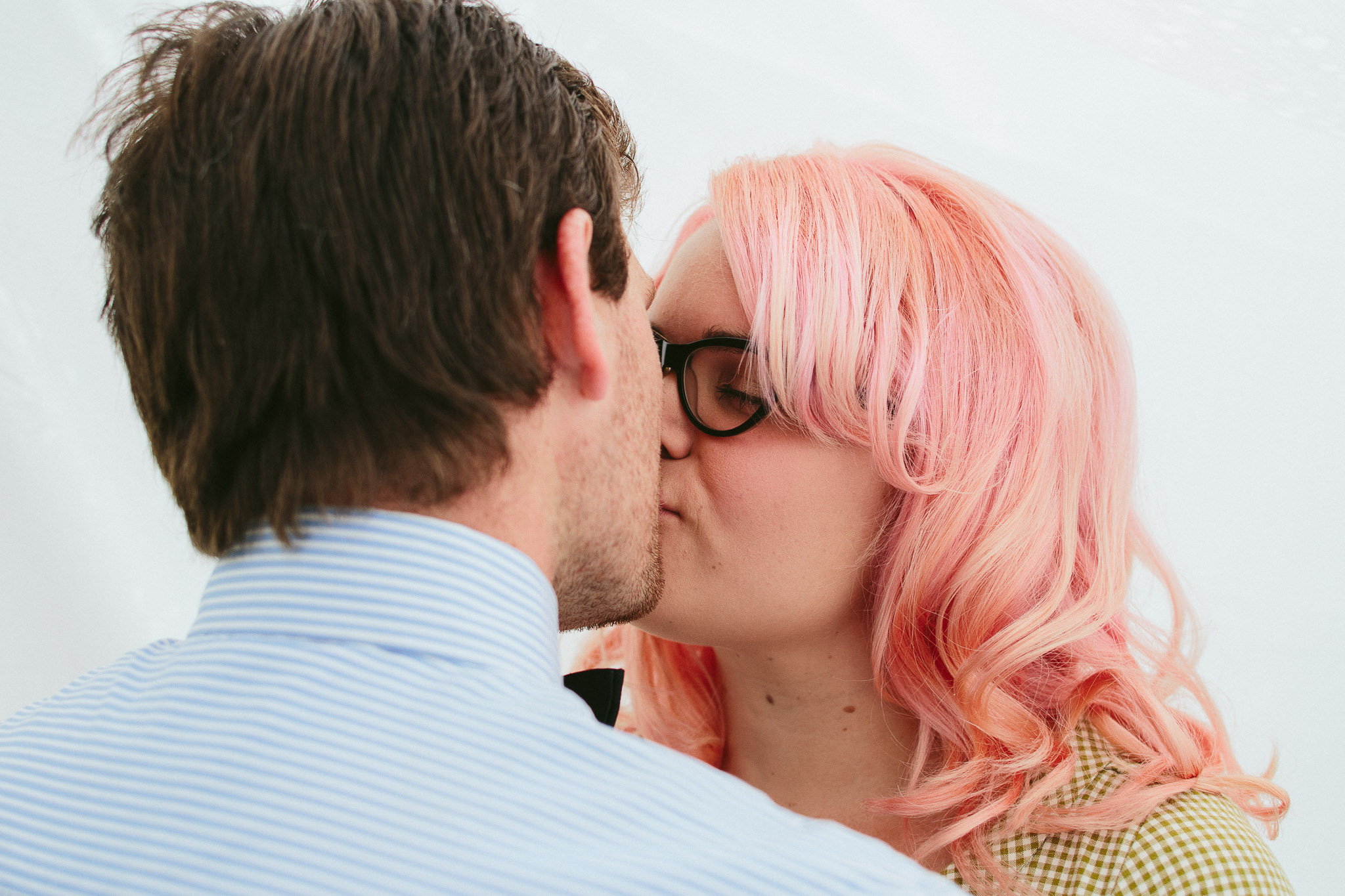 engagement images couple in sheets kiss