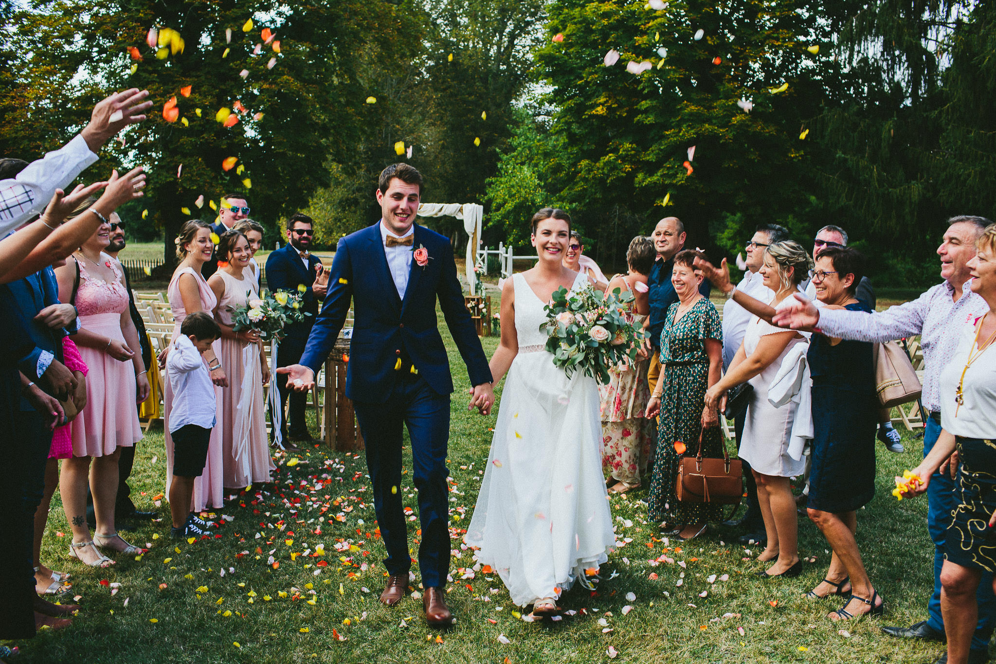 French British wedding walking down aisle flower throwing 