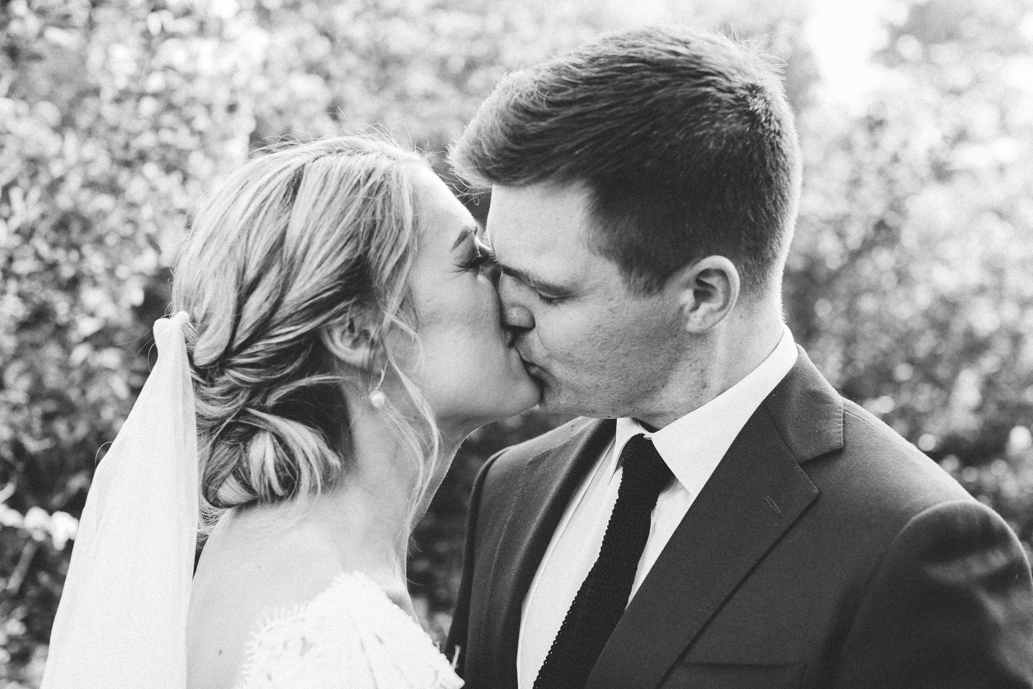 photo session portrait bride and groom kissing closeup 