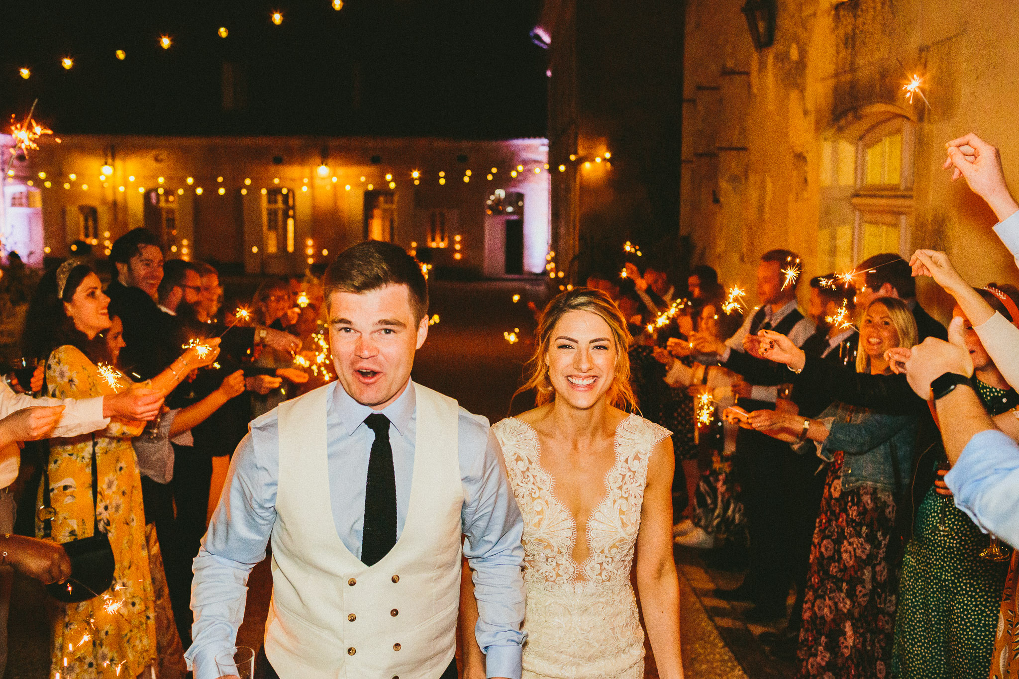 Lovely French destination wedding bride and groom sparklers walk and laughing and happy