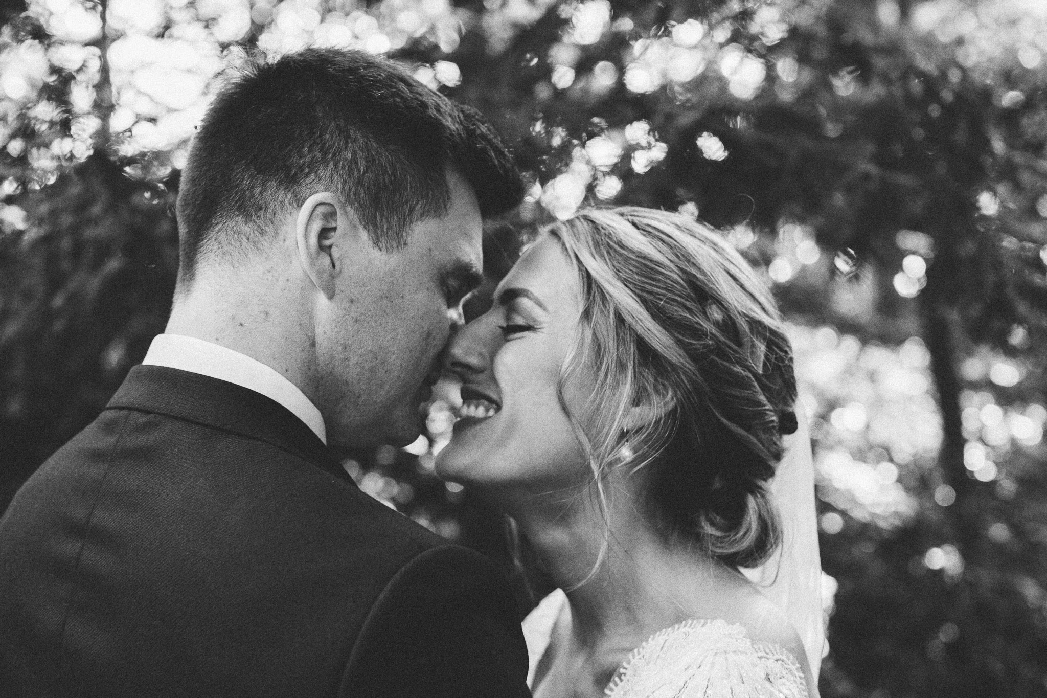 photo session portrait in woods groom walking to bride about to kiss