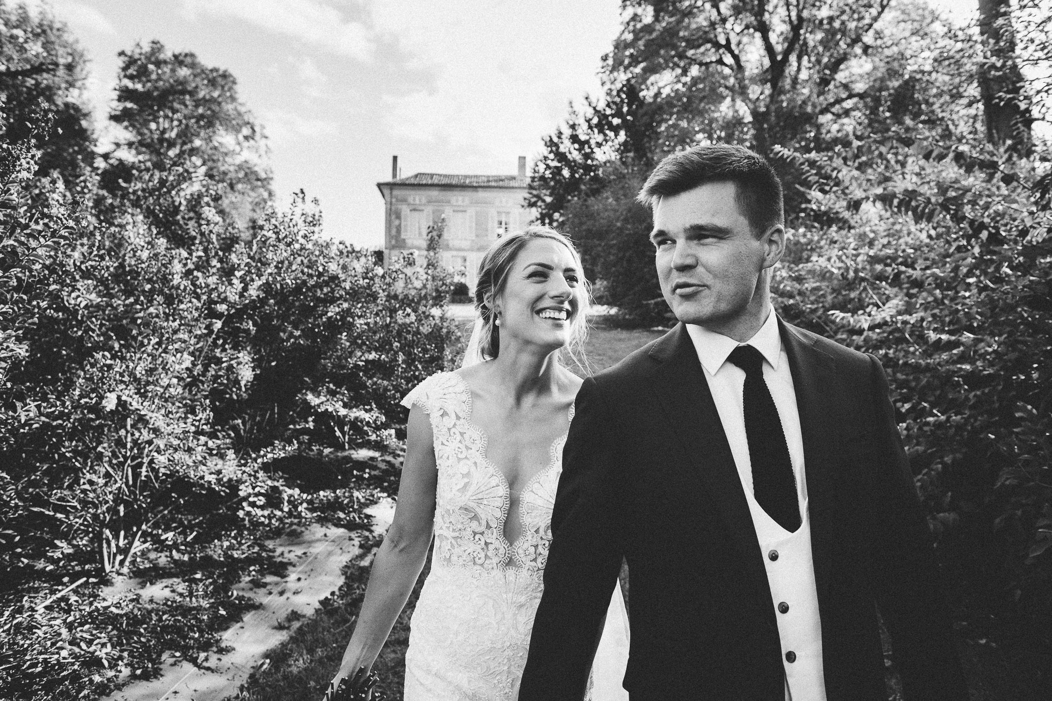 French destination wedding photo session portrait bride and groom laughing french domaine in background 