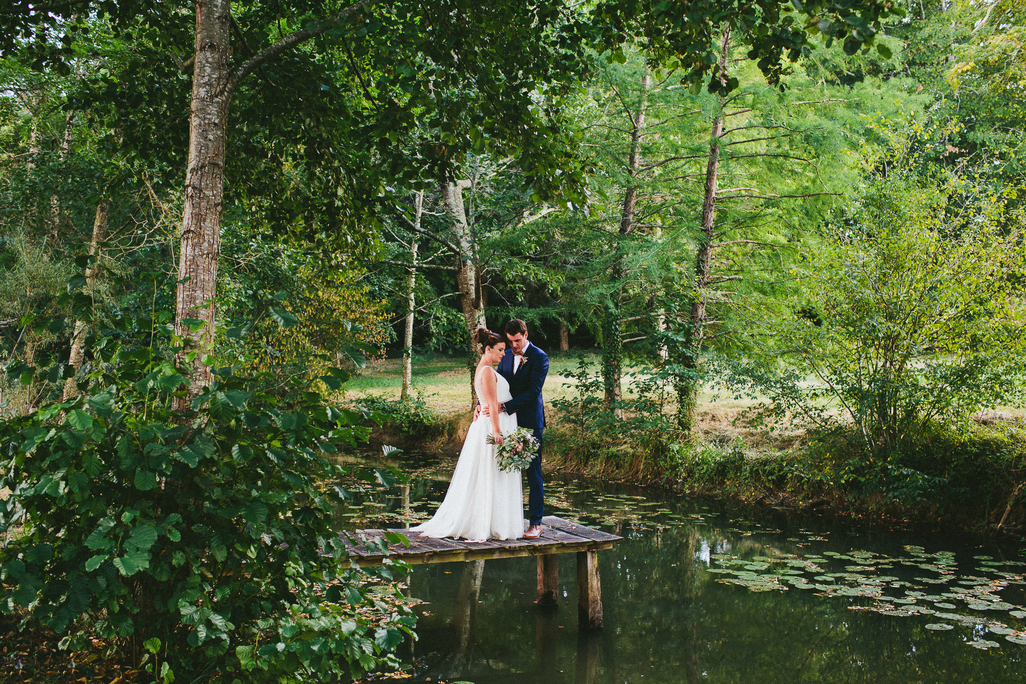 bride and groom by the river