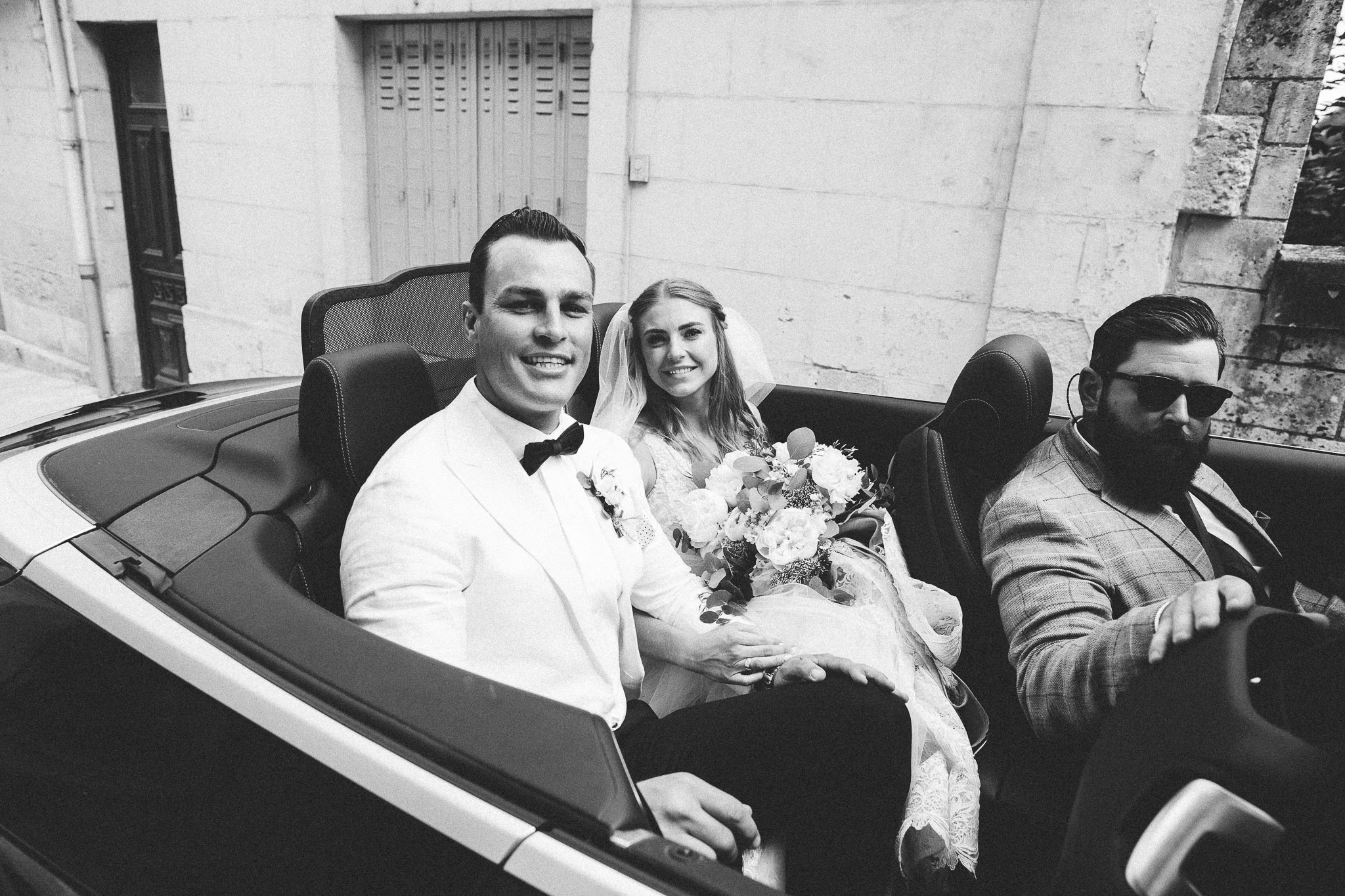 back of a car bride and groom