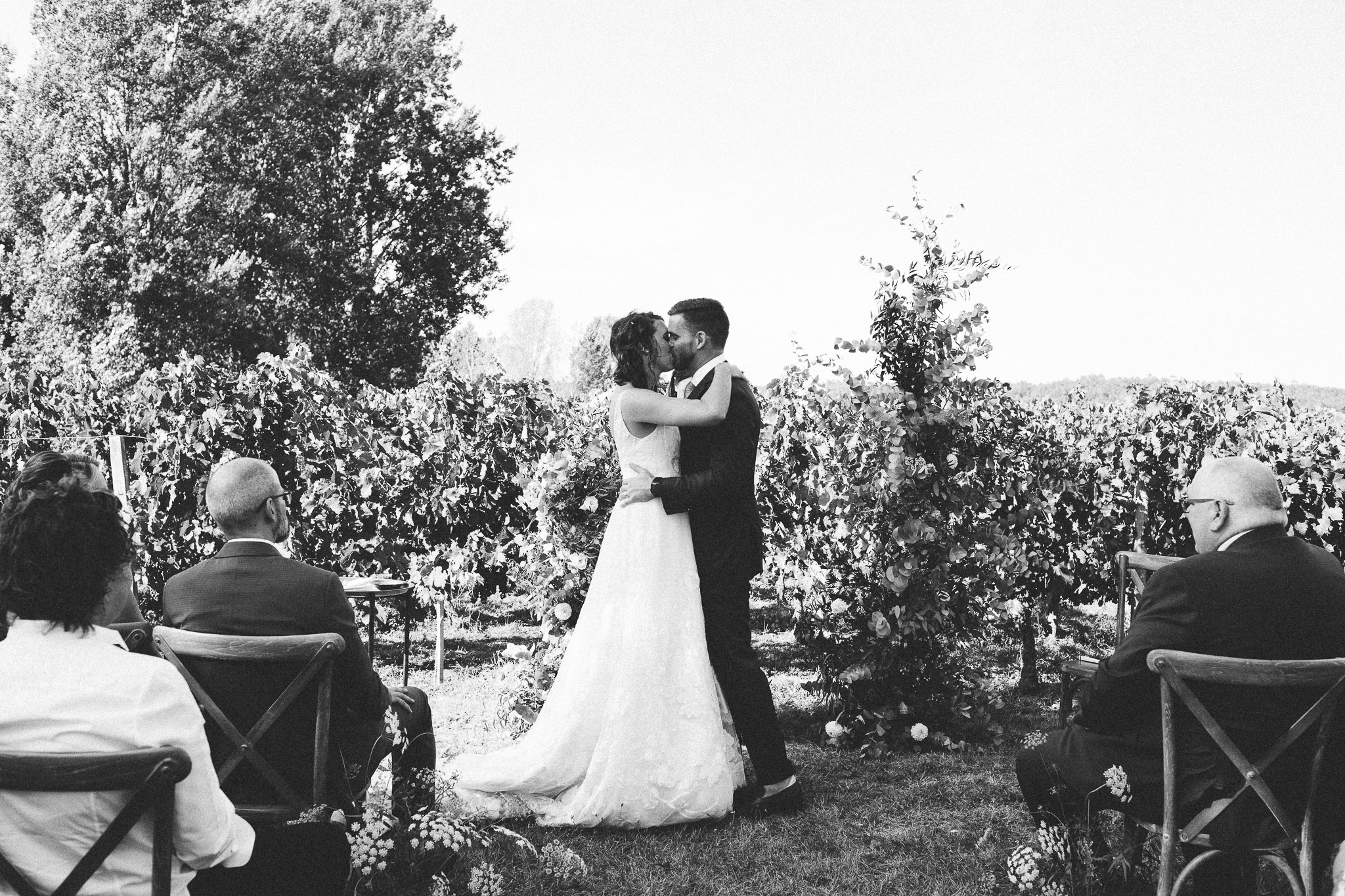 kissing at ceremony bride and groom