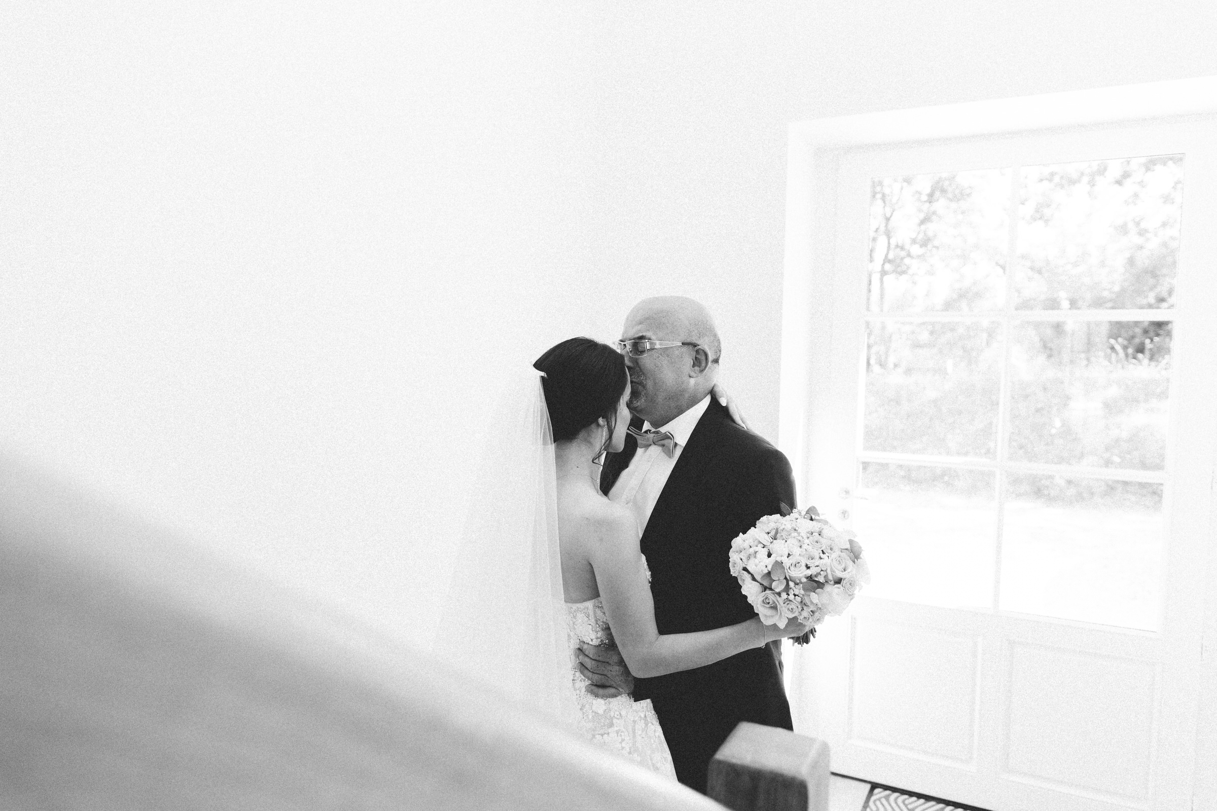 father kissing bride on forehead Classy french wedding