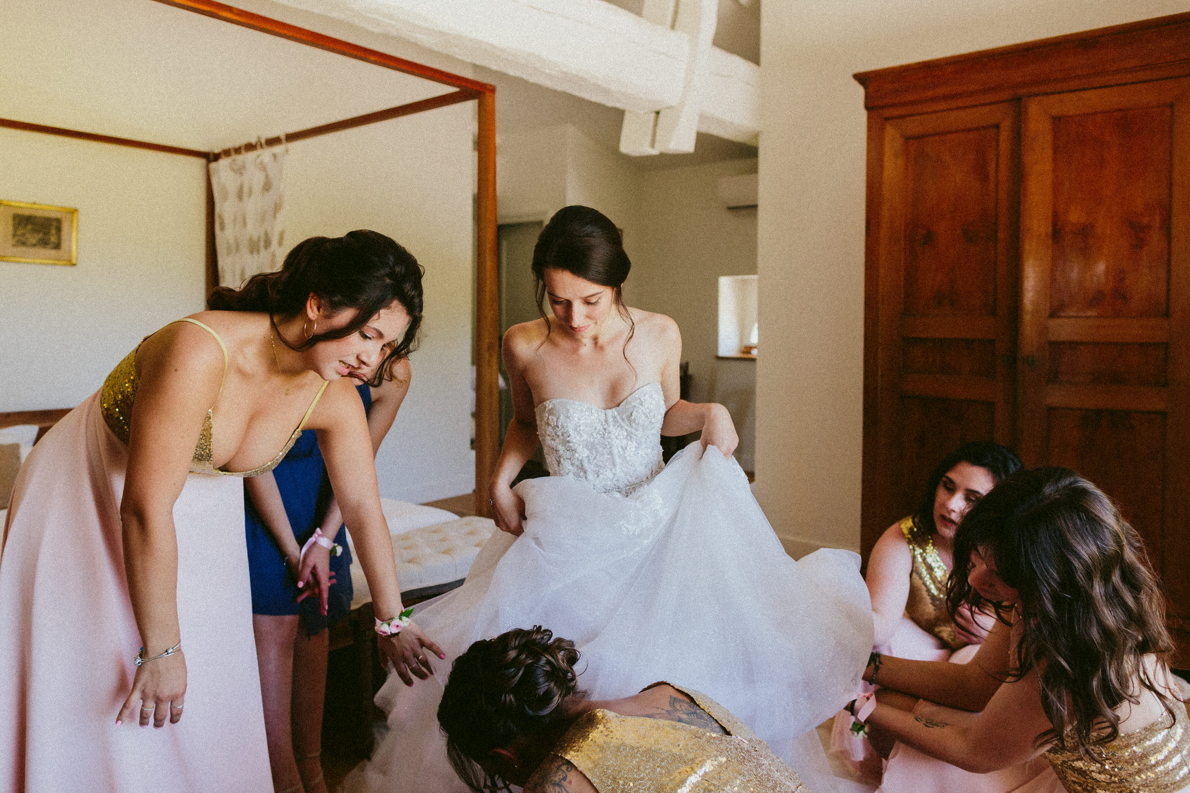 bridesmaid helping bride with wedding shoes Classy french wedding