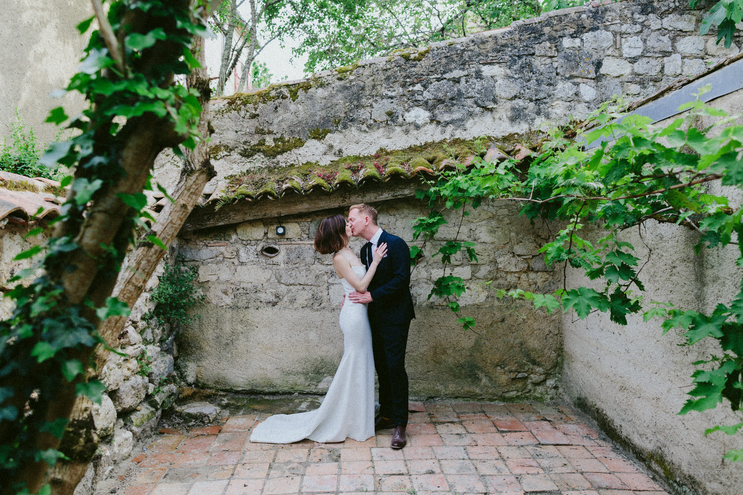 kissing in beautiful location bride and groom Castelnau des Fieumarcon french village wedding