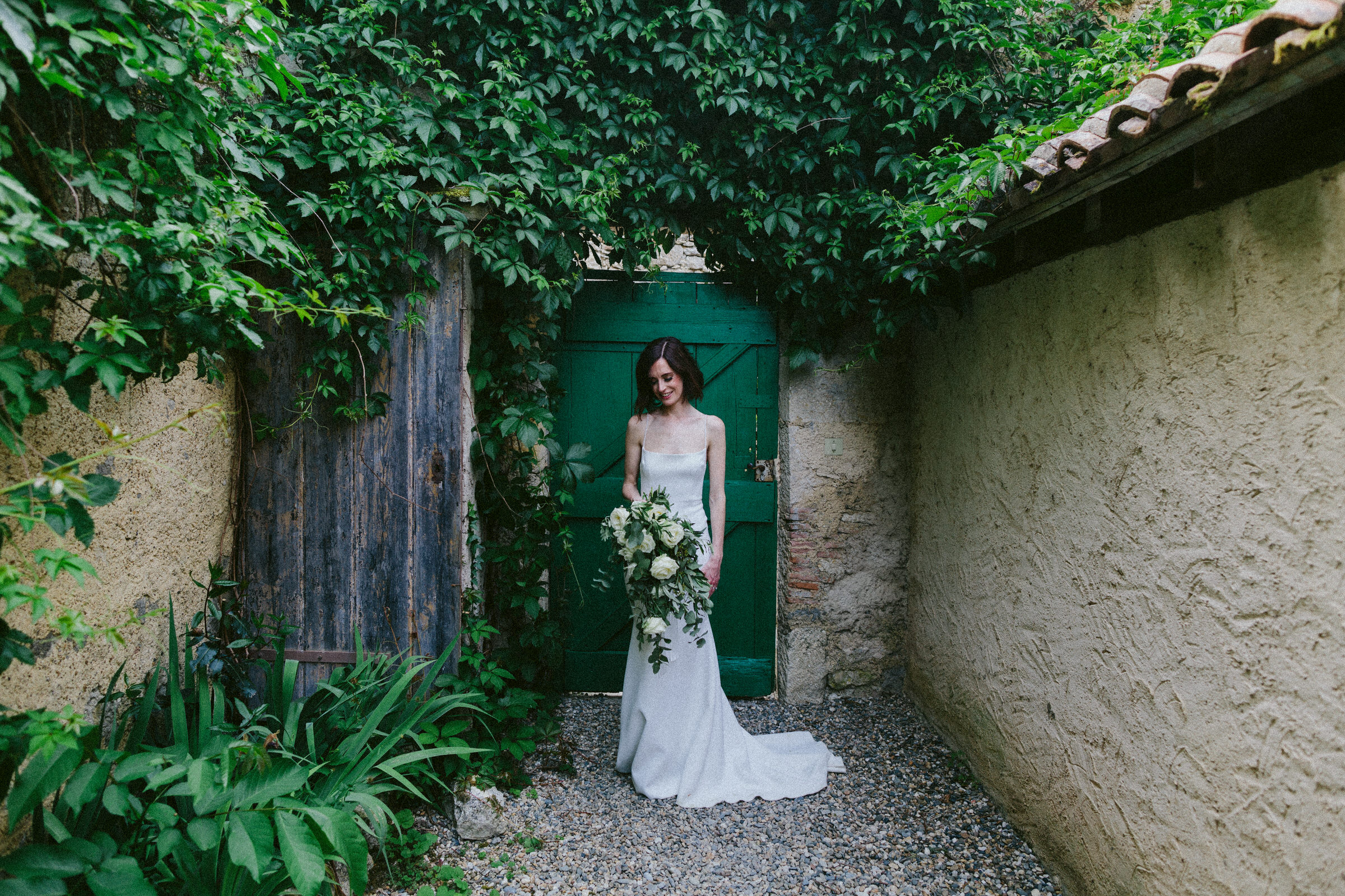 bride admiring her wedding bouquet Castelnau des Fieumarcon french village wedding
