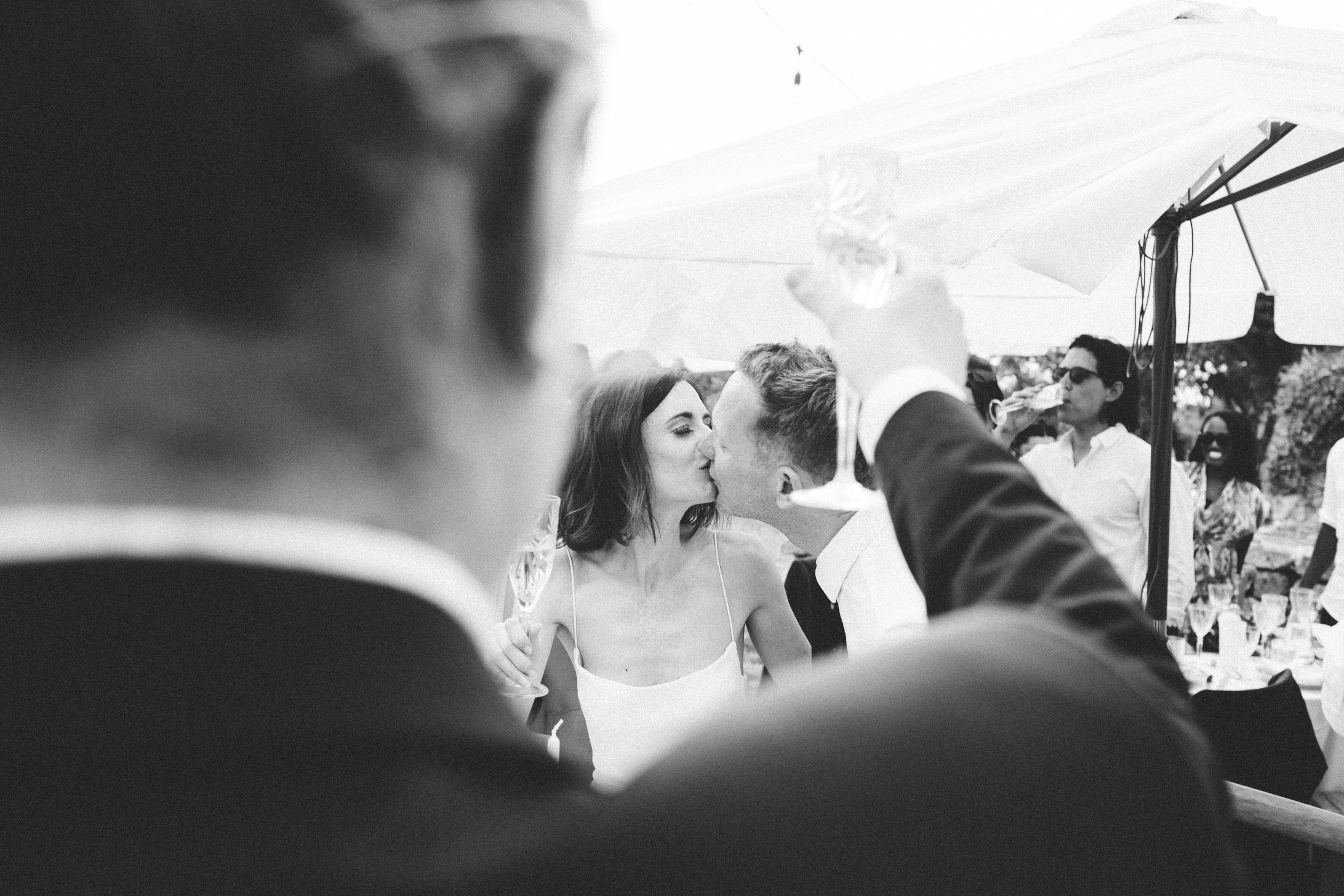 bride and groom kiss during wedding speech Castelnau des Fieumarcon french village wedding